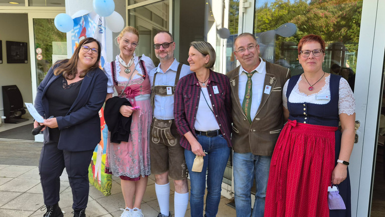 Mitarbeitende stehen zum Teil in bayerischer Tracht vor dem Eingang der Immanuel Klinik Märkische Schweiz Mitarbeitende stehen zum Teil in bayerischer Tracht vor dem Eingang der Immanuel Klinik Märkische Schweiz